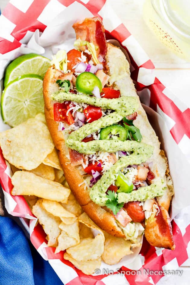 Tex mex hot dog in a basket with potato chips