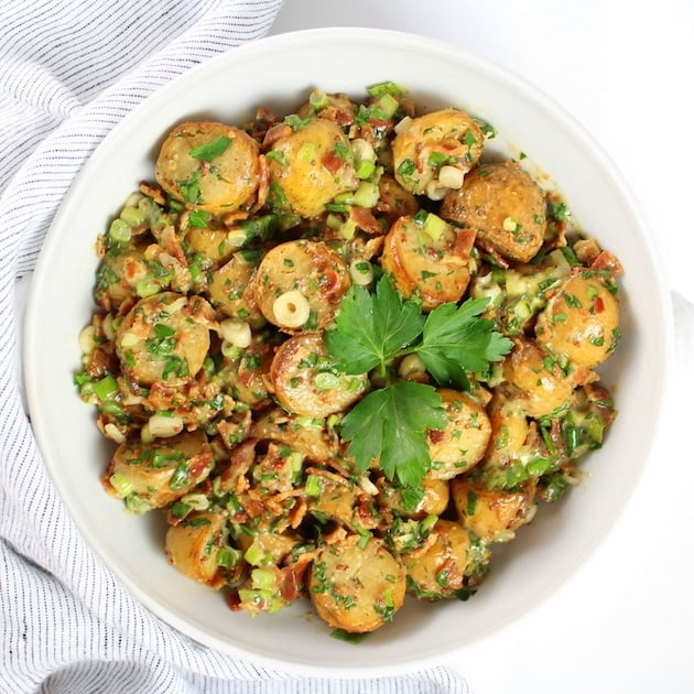 Smoky Salt and Vinegar Potato Salad in a white serving bowl