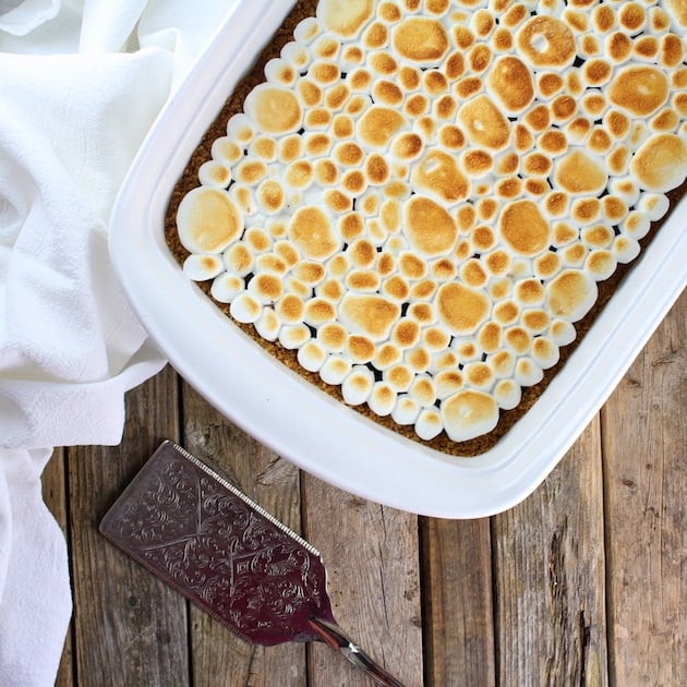 Partial pan of toasted marshmallows on top of Baked Nutella S\'mores dessert