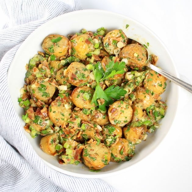 Potato Salad with serving spoon and white bowl