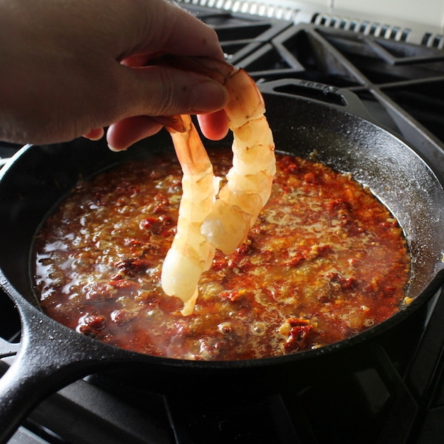 Adding shrimp to skillet for Sun-Dried Tomato Chorizo Garlic Shrimp