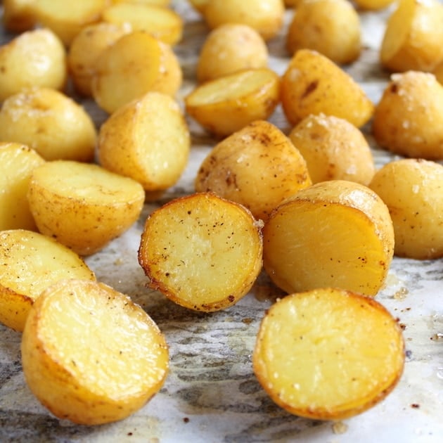 Close up baked baby potatoes on cookie sheet