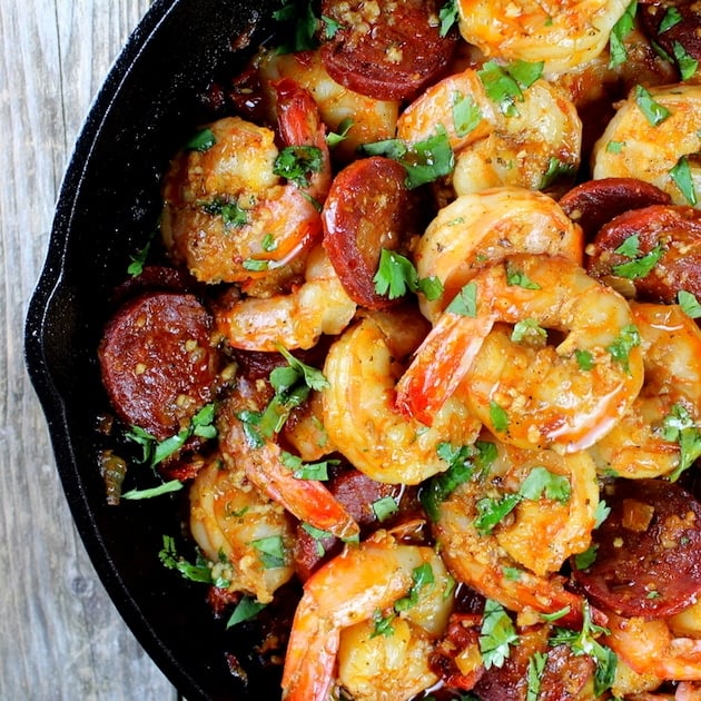 Partial cast iron skillet with Sun-Dried Tomato Chorizo Garlic Shrimp