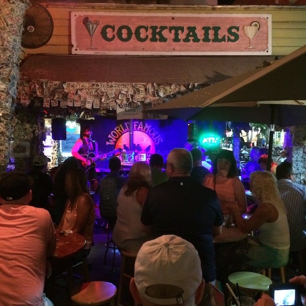 Musician playing live in front of crowd at a bar