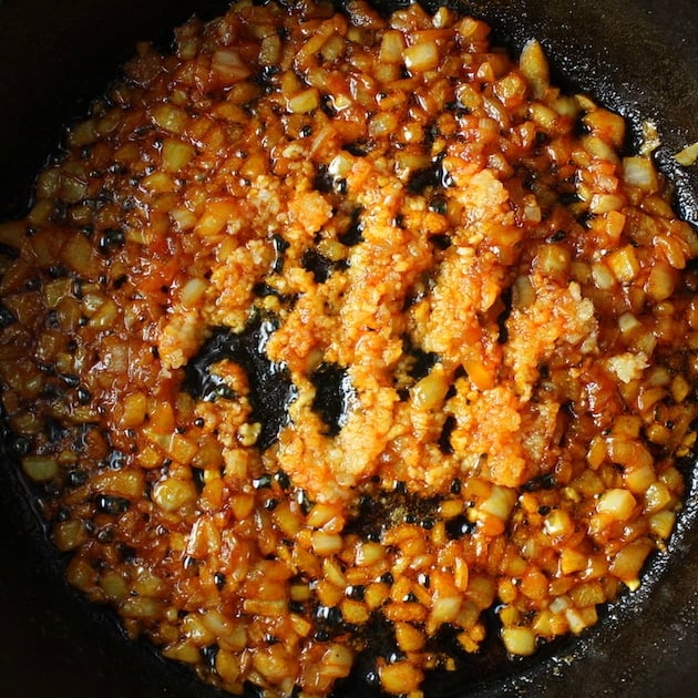 Onion and garlic cooking in skillet