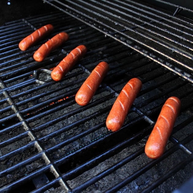 Hot dogs grilling on grill