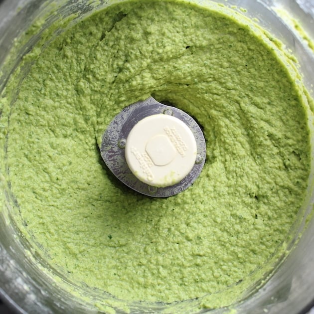 Spicy green hummus in food processor after mixing