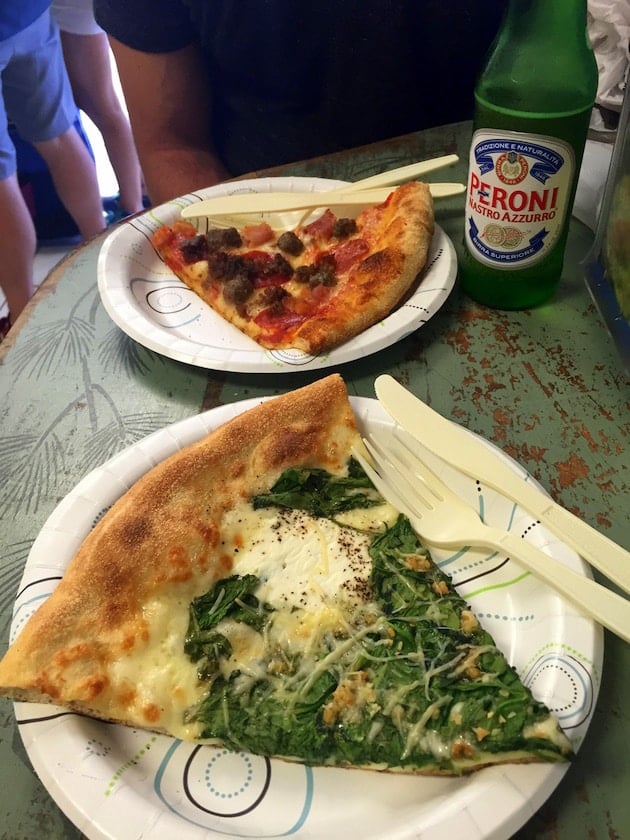 Slices of pizza on paper plates with bottle of Italian beer from Duetto Pizza &amp; Gelato in Key West