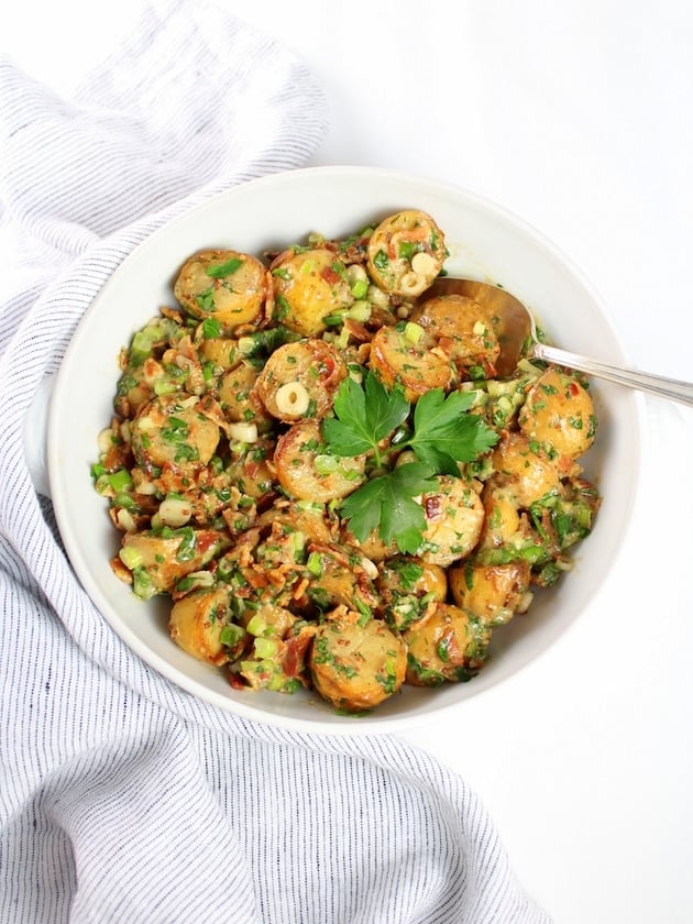 Salt and Vinegar Potato Salad in serving bowl with striped napkin