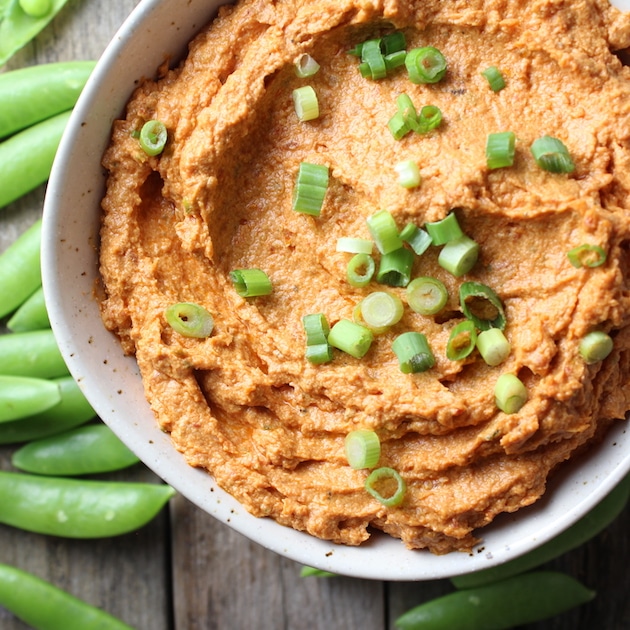 Sun-Dried Tomato Goat Cheese Dip in a bowl with chopped green onions