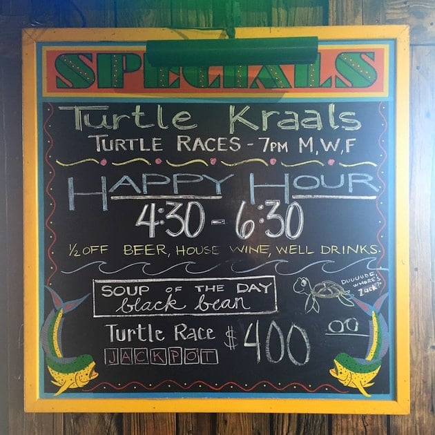 Chalkboard of bar specials and turtle race schedule at Turtle Kraals Key West 