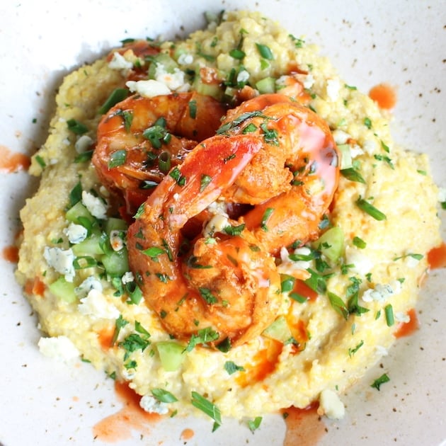 Close up over top Buffalo Shrimp and Blue Cheese Grits