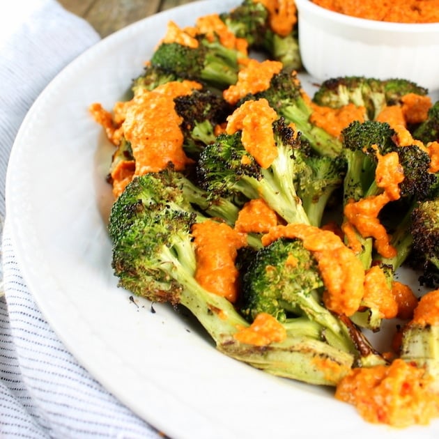 Eye level platter of Grilled Broccoli with Red Sauce