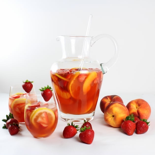 A bowl of fruit on a table, with Peach and Sangria