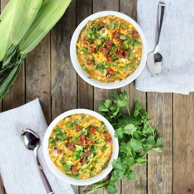 A bowl of food on a wooden table, with Chicken and Chowder