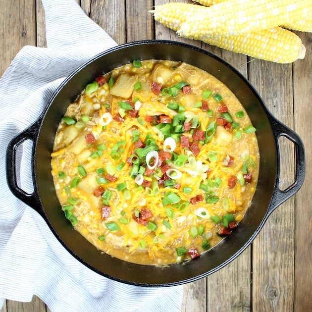 Large cast iron soup pot full of corn chowder