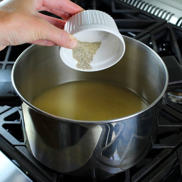 Adding salt and pepper to a pot