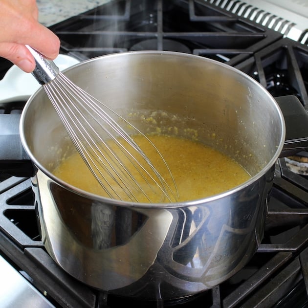 whisking polenta on the stove