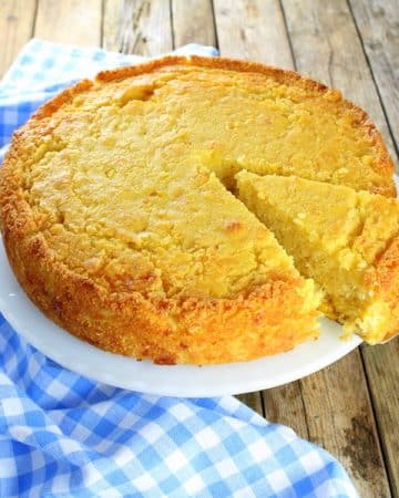 Cornbread on a plate with slice partially removed