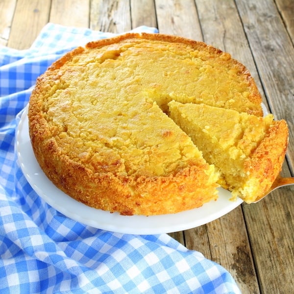 Cornbread on a plate with slice partially removed