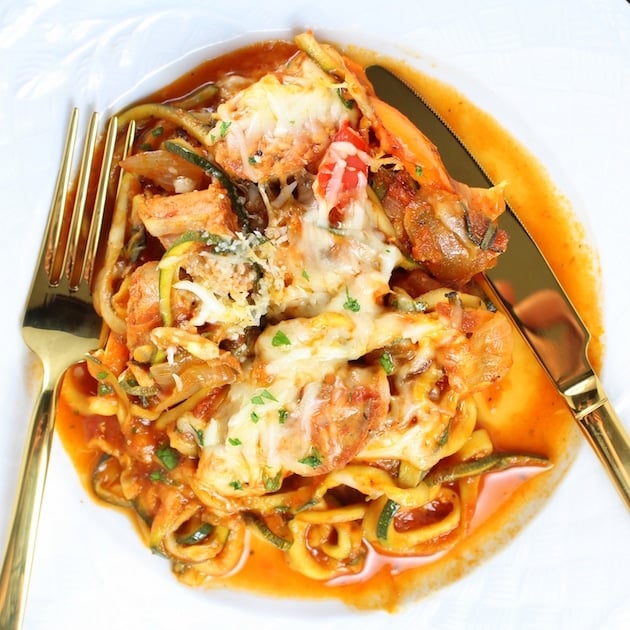 A plate of Italian sausage with peppers and zoodles