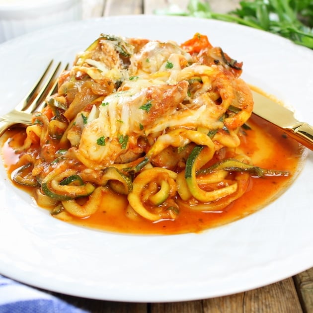 Eye level plate full of Sausage and Peppers with Zucchini Noodles