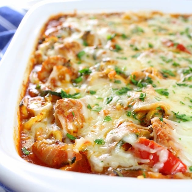 Eye level partial casserole dish of Sausage and Peppers with Zucchini Noodles