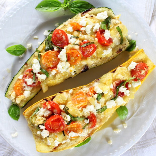 Two Tomato Feta stuffed Grilled Zucchini and Squash on a plate