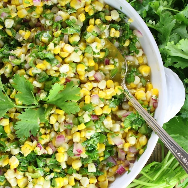 Jalapeño Cilantro Corn Salad in a serving dish with spoon