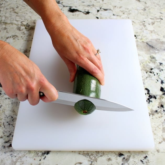 slicing ends off a fresh zucchini
