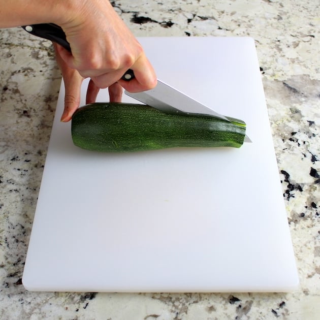 Slicing a zucchini in half lengthwise