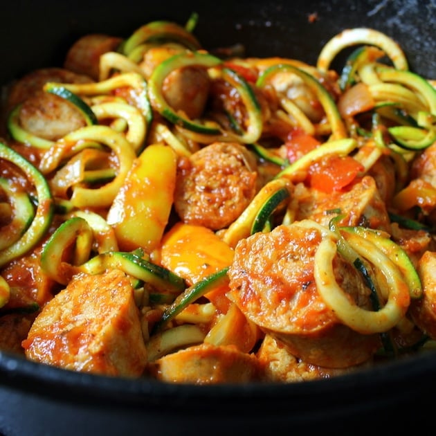 A close up of Italian sausage with peppers and zoodles