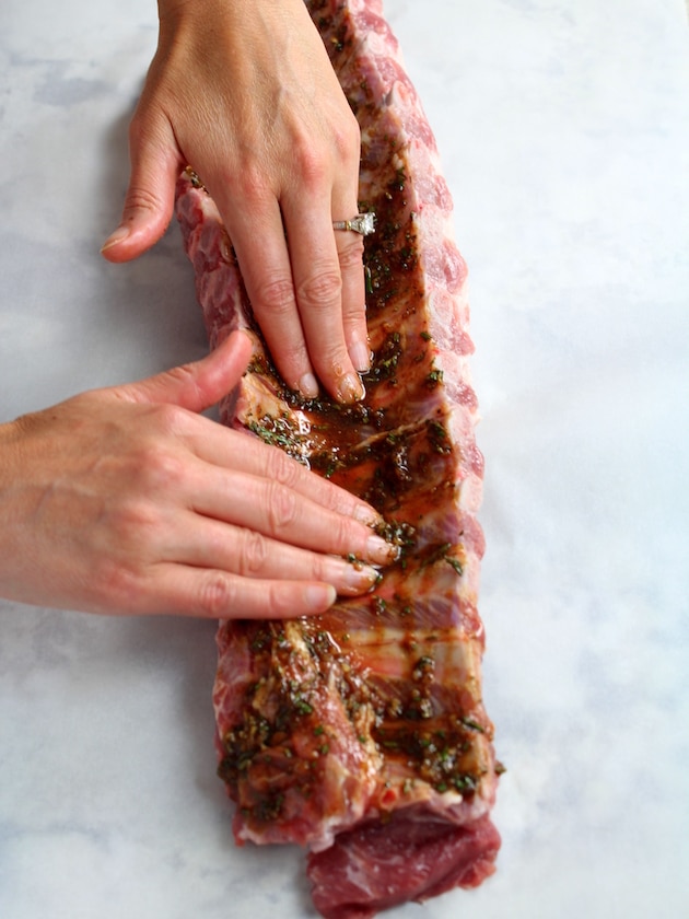 Dry rubbing a rack of baby back ribs