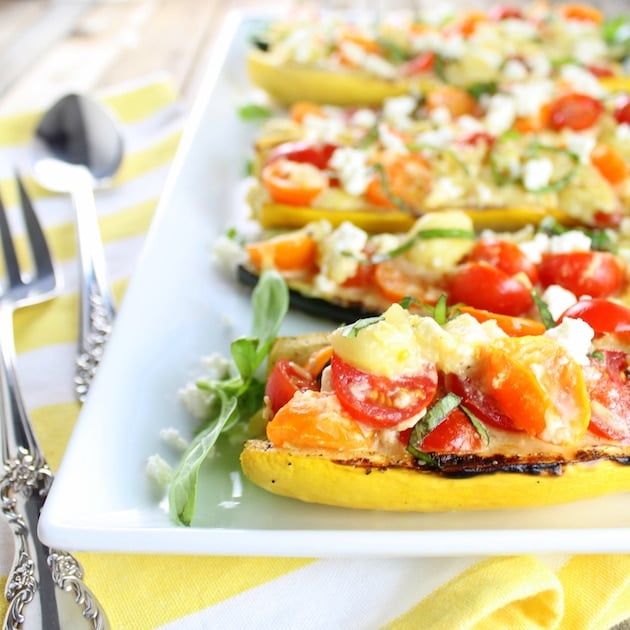 Eye level close up  grilled squash stuffed with tomatoes and feta