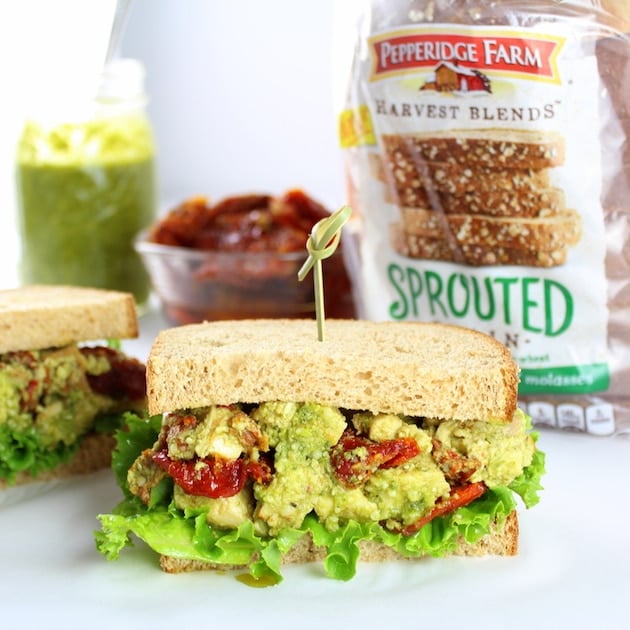 Eye level halves of a Chicken salad sandwich on parchment paper