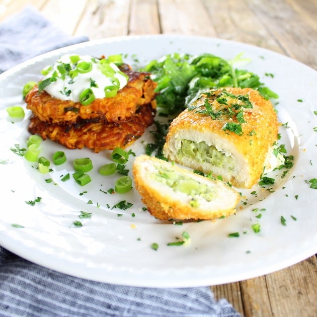 Eye level dinner plate of Parmesan Sweet Potato Cakes With Broccoli Cheese Chicken