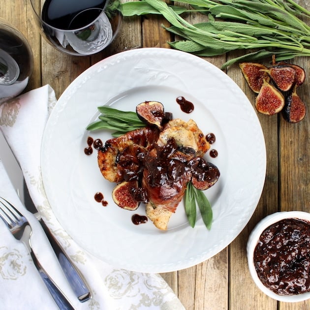 A plate of chicken cutlets wrapped in prosciutto with sage