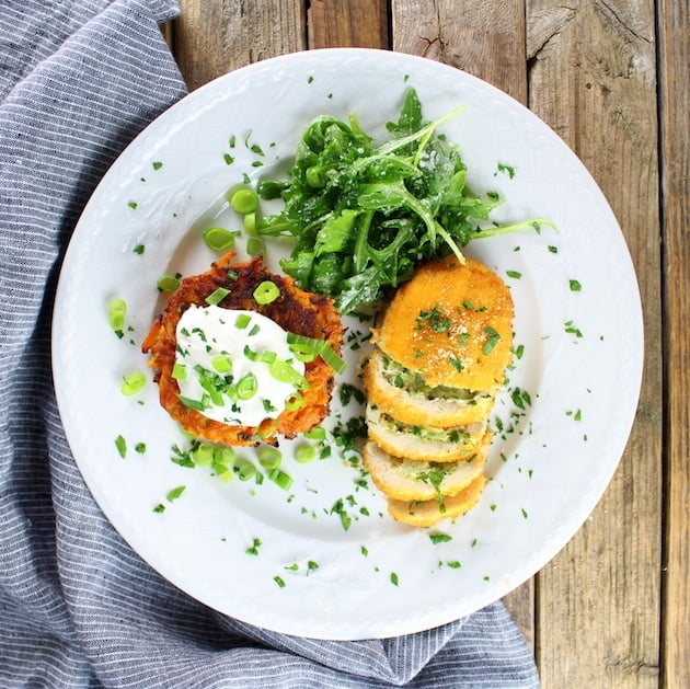 Plate of Parmesan Sweet Potato Cakes With Broccoli Cheese Chicken and a side salad