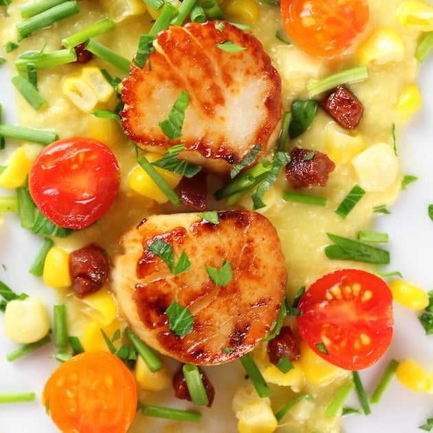 Very Close up over top two seared scallops on a bed of corn puree