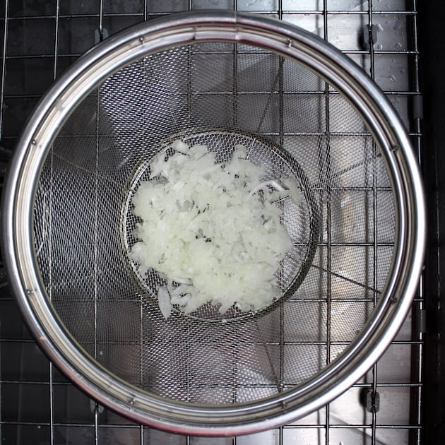 Draining grated onion in a strainer