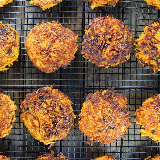 Sweet potato cakes cooling on a wire rack after frying