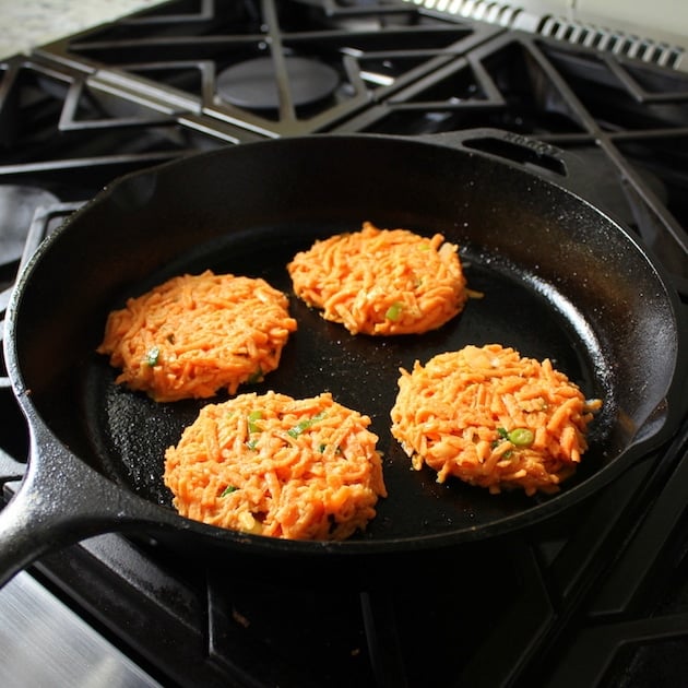 Sweet potato cakes frying in a pan