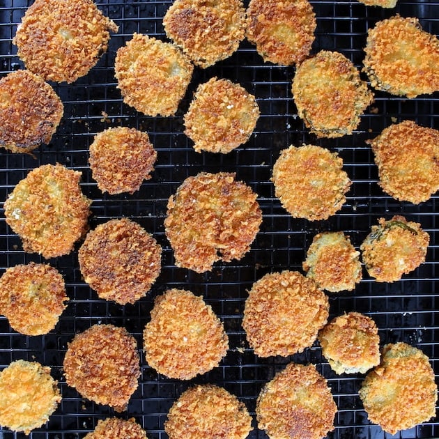 breaded fried pickles cooking on a wire rack