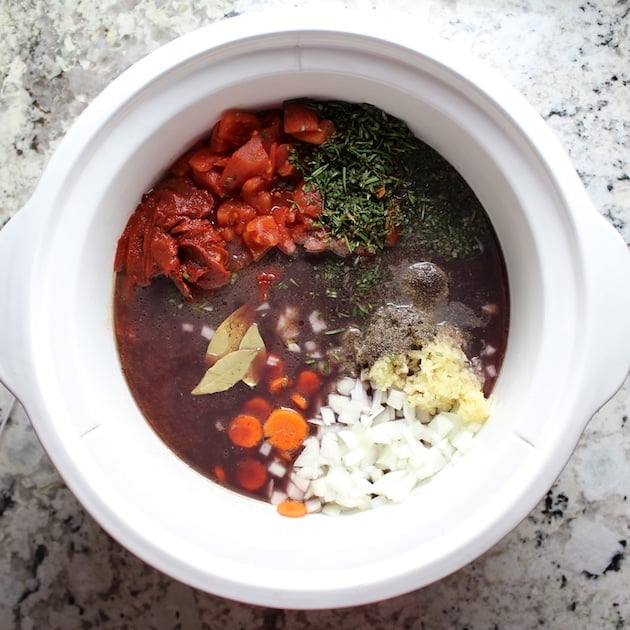 Crockpot with ingredients for slow-cooker Beef Ragu