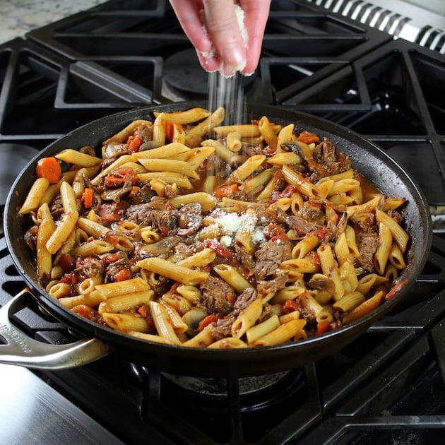 Adding parmesan to saute pan with Beef Ragu