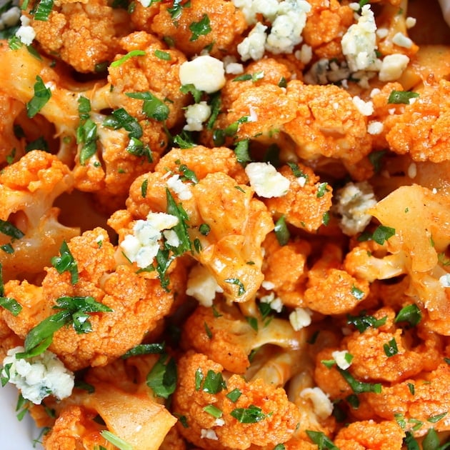 Close up of orange Buffalo Cauliflower with Blue Cheese crumbles