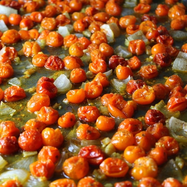 Cooked cherry tomatoes on baking sheet