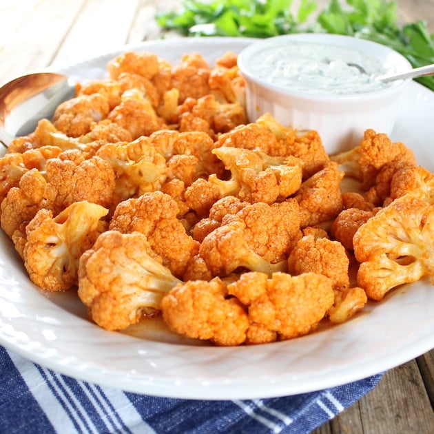 Partial eye level plate of Buffalo Cauliflower with Blue Cheese Sauce