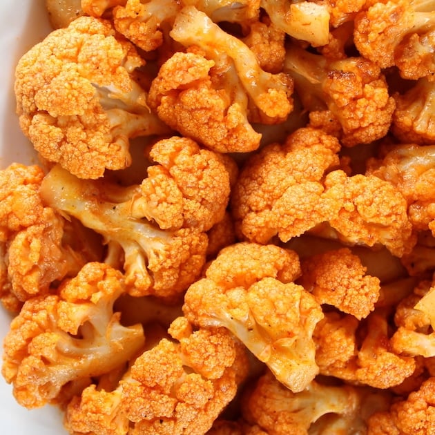 Close up of orange cauliflower that\'s been cooked in buffalo sauce