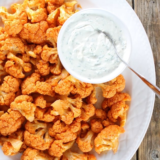 Partial platter over top Roasted Buffalo Cauliflower with Cheesy dipping Sauce